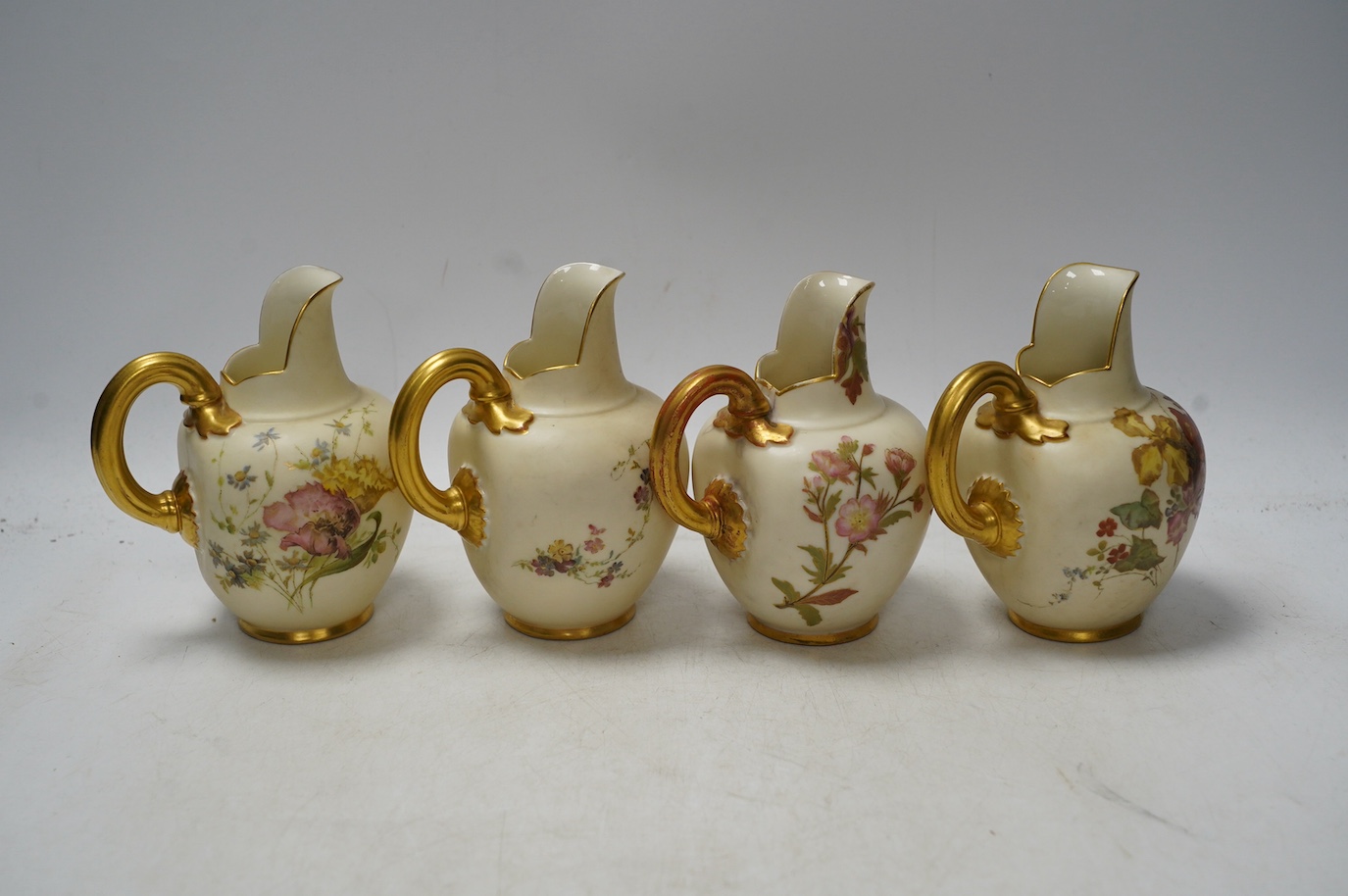 Four Worcester 1094 shape blush ivory floral jugs, 13cm high. Condition - good, some wear